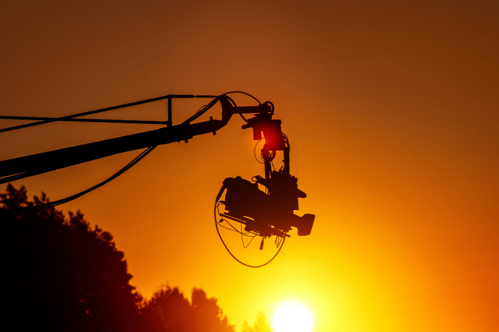 TV camera on a crane on football match or concert.